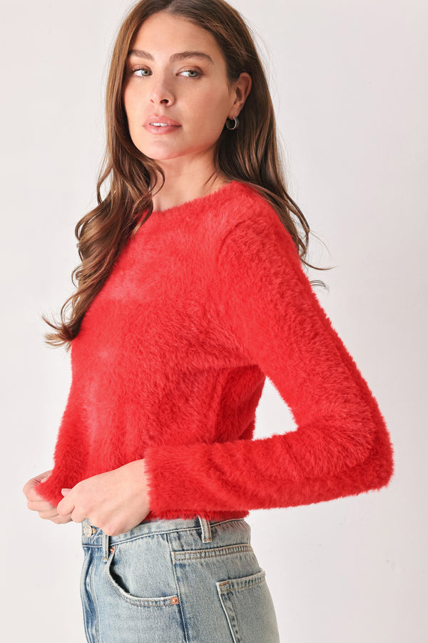 A woman wearing a fuzzy, textured red long-sleeve crop sweater | FREEMARKET