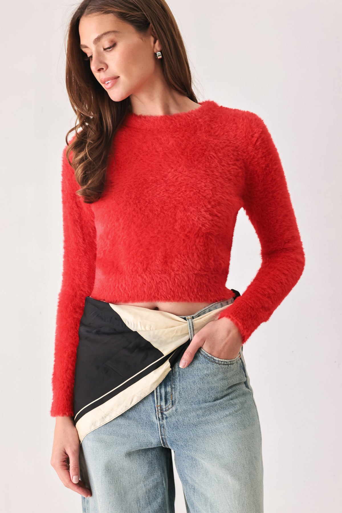 A woman wearing a bright red fuzzy long-sleeve crop top | FREEMARKET