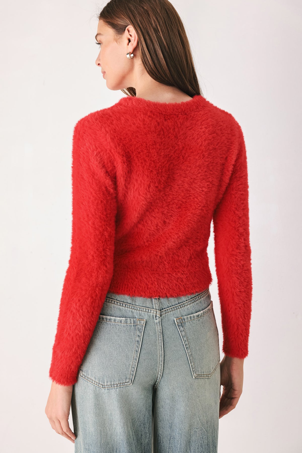 A woman wearing a fuzzy, textured red long-sleeve crop sweater | FREEMARKET