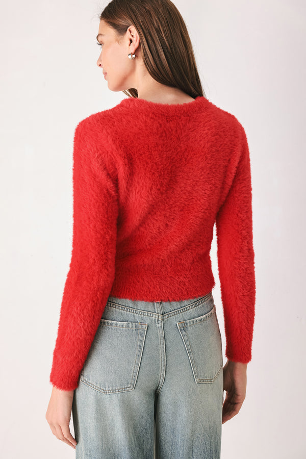 A woman wearing a fuzzy, textured red long-sleeve crop sweater | FREEMARKET