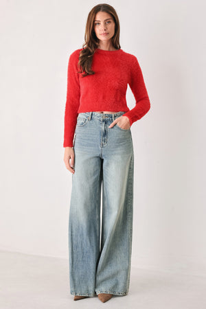 A woman wearing a fuzzy, textured red long-sleeve crop sweater | FREEMARKET