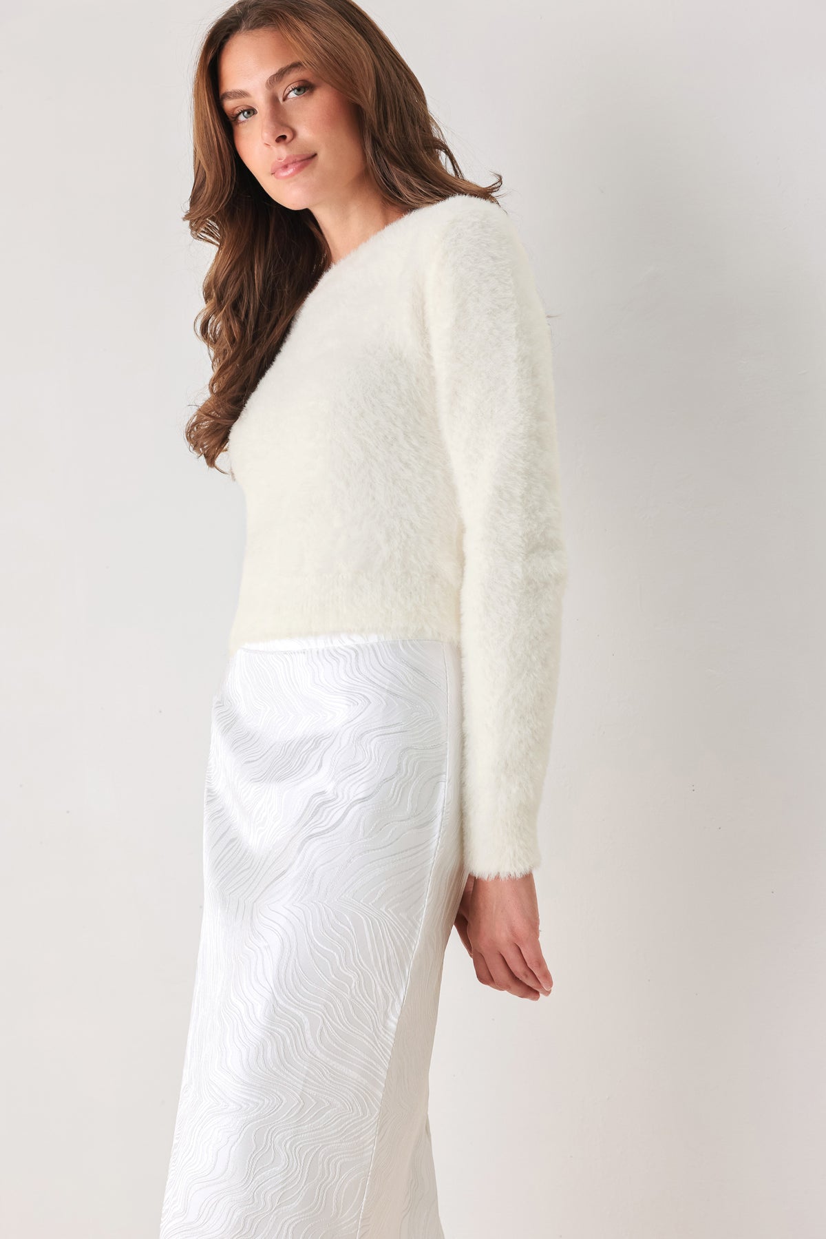 A woman modeling a fuzzy off-white long-sleeve sweater top | FREEMARKET