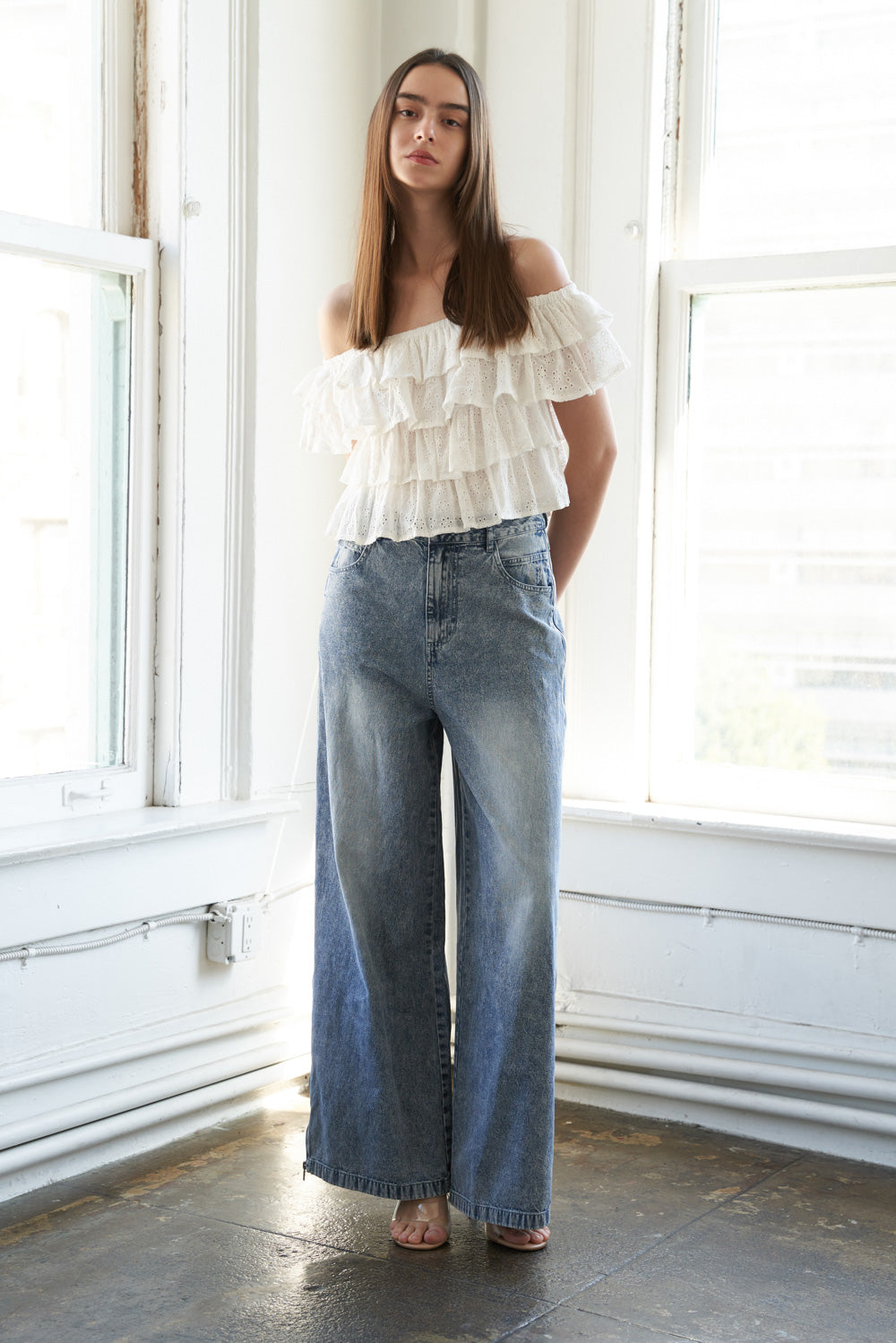 A woman wearing a white-colored off-the-shoulder ruffled crop top | FREEMARKET