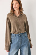 Woman wearing a brown button-up shirt bodysuit | FREEMARKET