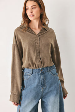 Woman wearing a brown button-up shirt bodysuit | FREEMARKET