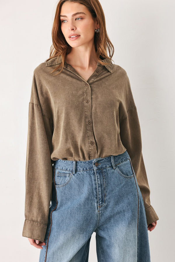 Woman wearing a brown button-up shirt bodysuit | FREEMARKET