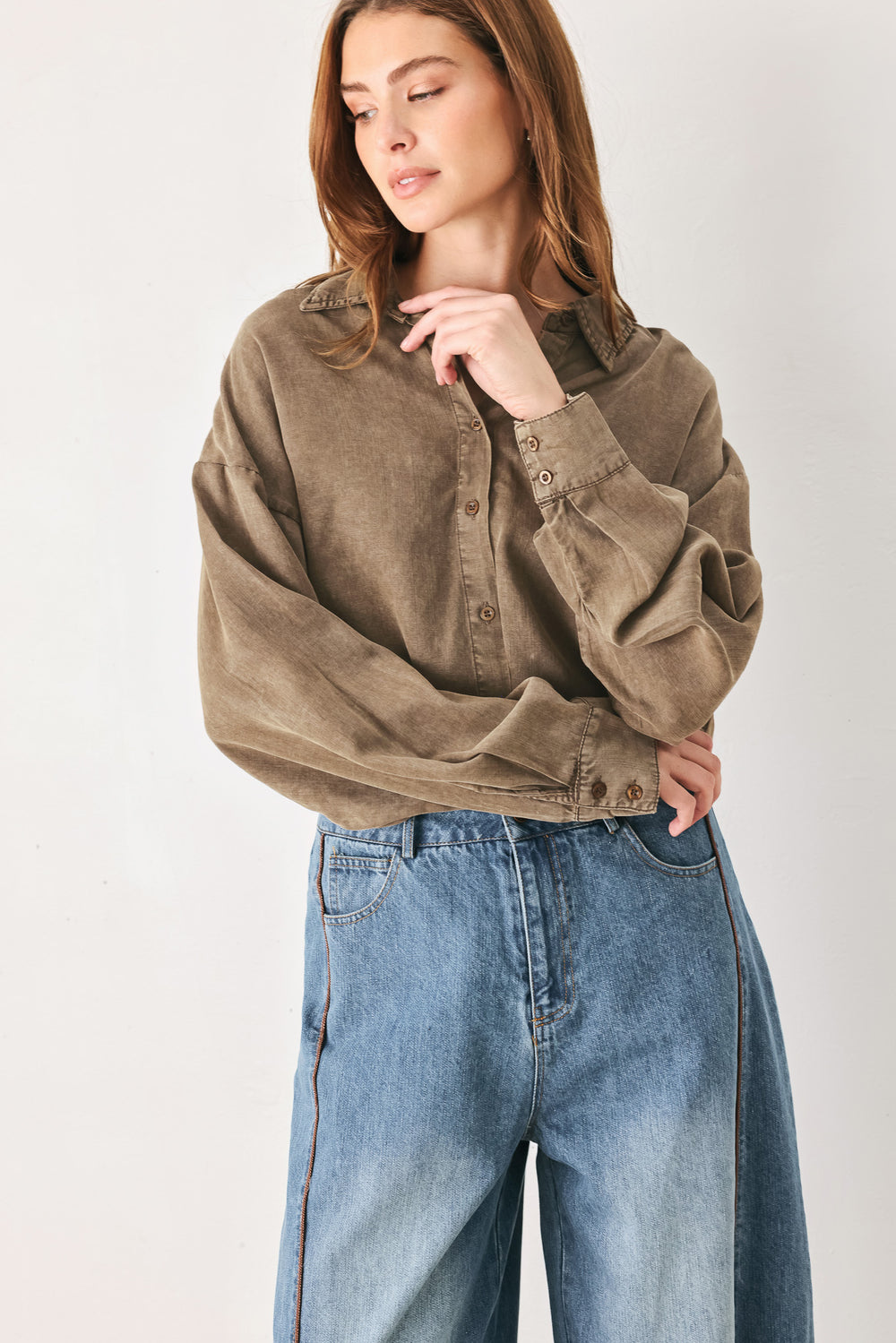 Woman wearing a brown button-up shirt bodysuit | FREEMARKET