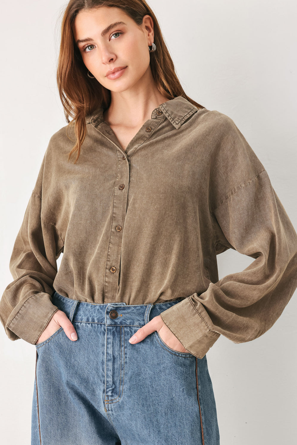 Woman wearing a brown button-up shirt bodysuit | FREEMARKET