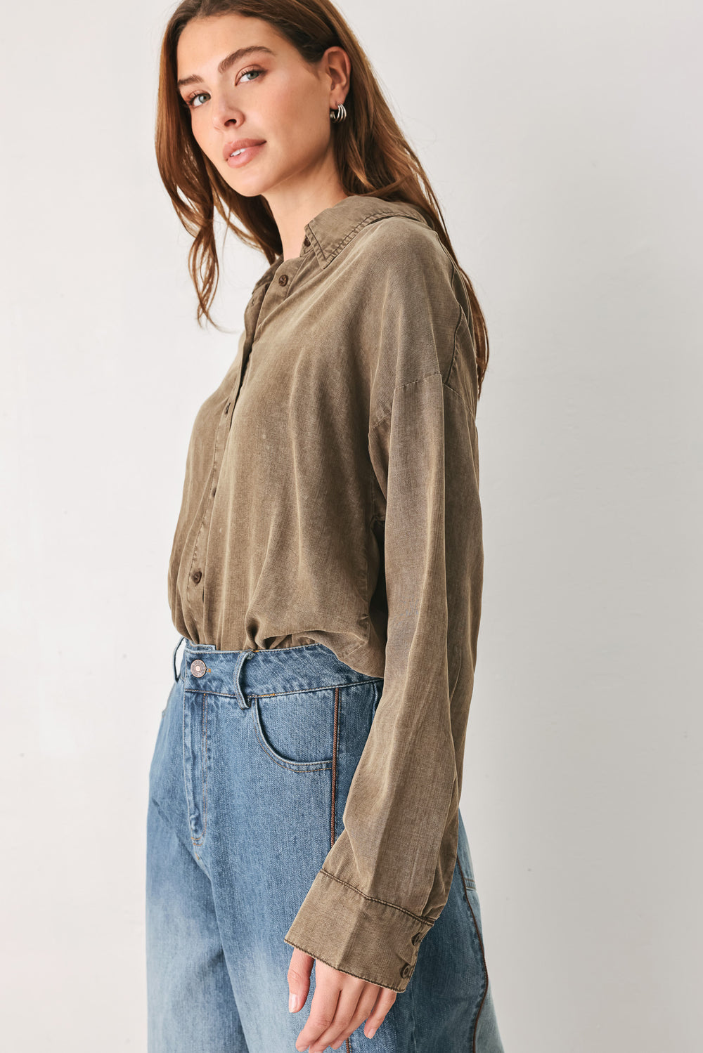 Woman wearing a brown button-up shirt bodysuit | FREEMARKET