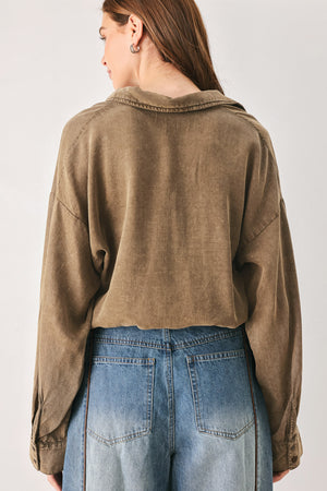 Woman wearing a brown button-up shirt bodysuit | FREEMARKET