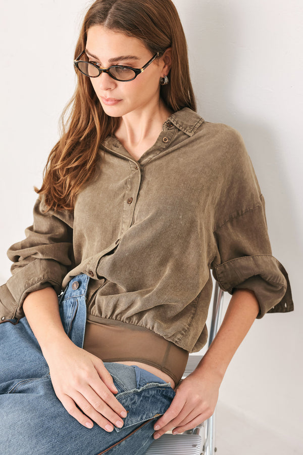 Woman wearing a brown button-up shirt bodysuit | FREEMARKET