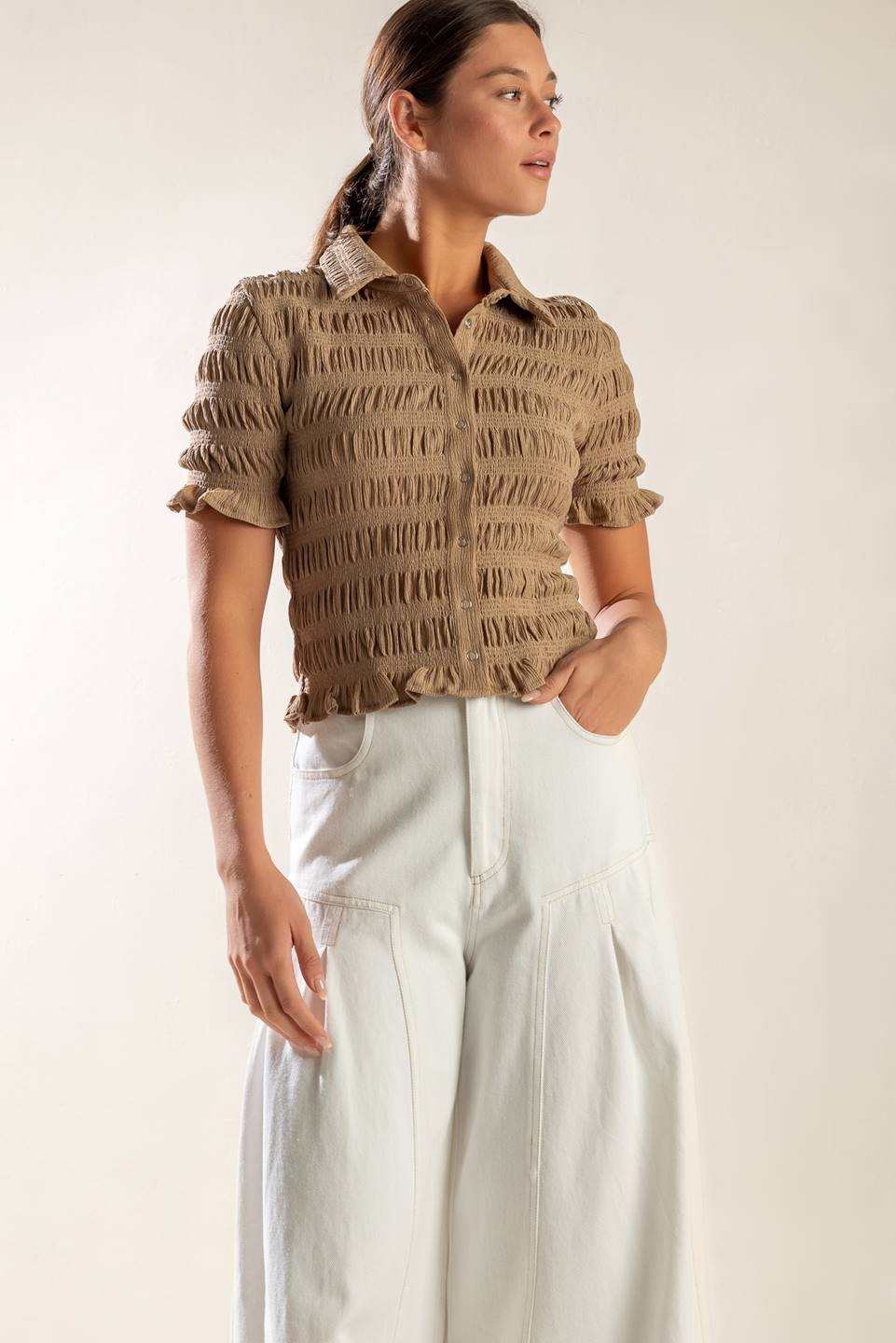 Expertly crafted, this textured woven top boasts a classic shirt collar, button down closure, and short sleeves.