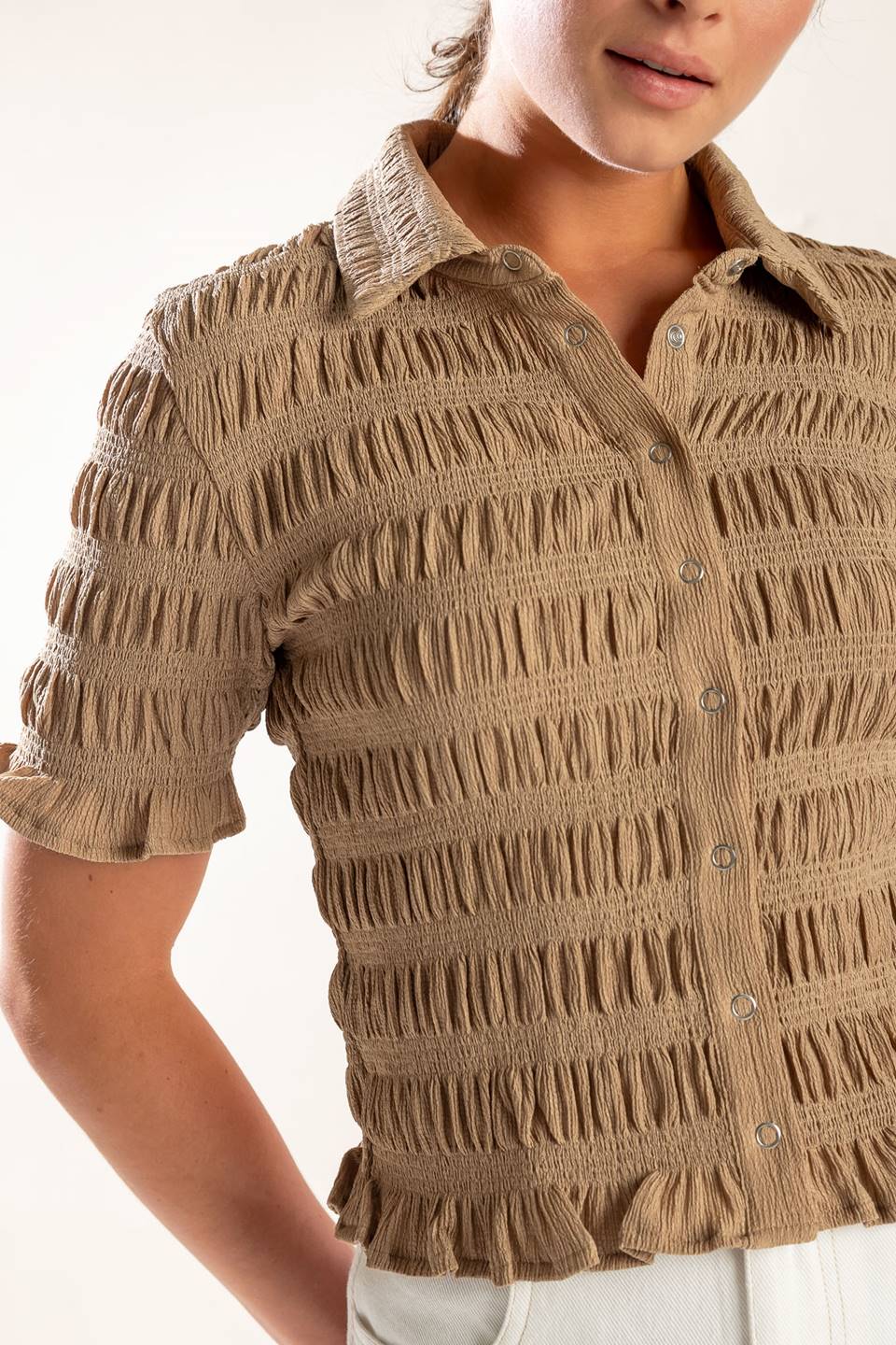 Expertly crafted, this textured woven top boasts a classic shirt collar, button down closure, and short sleeves.