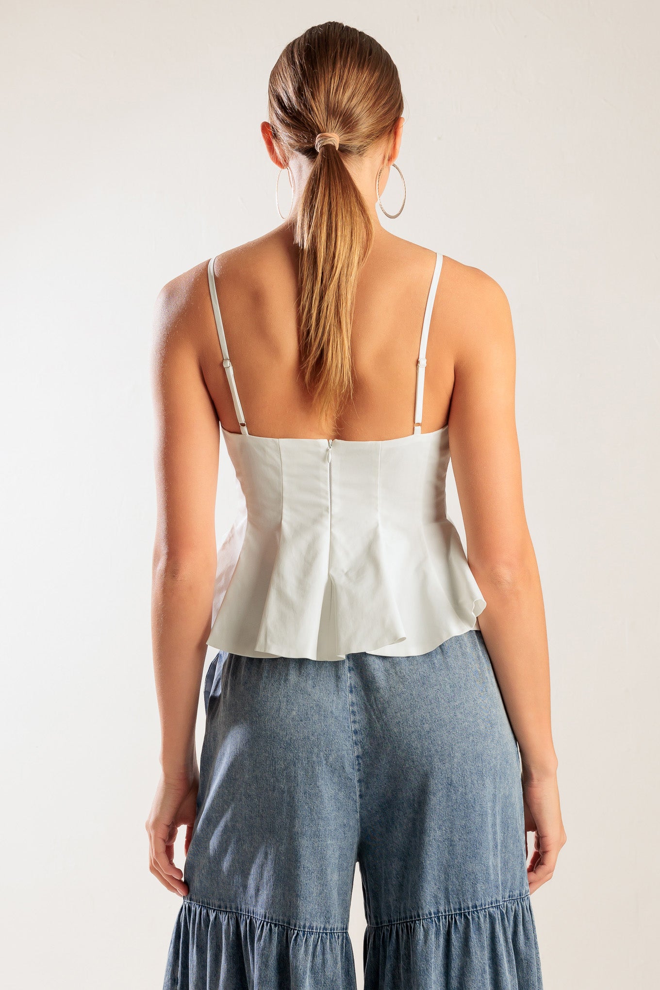 
A solid woven cami top featuring straps, peplum and back zipper closure. Matching pants FP1095.

Details:

Self : 100% Polyester

Size &amp; Fit

- Model is 5`8" And Wearing Size Small
- Measurements Taken From Size Small
- Approx. Length: 22"
