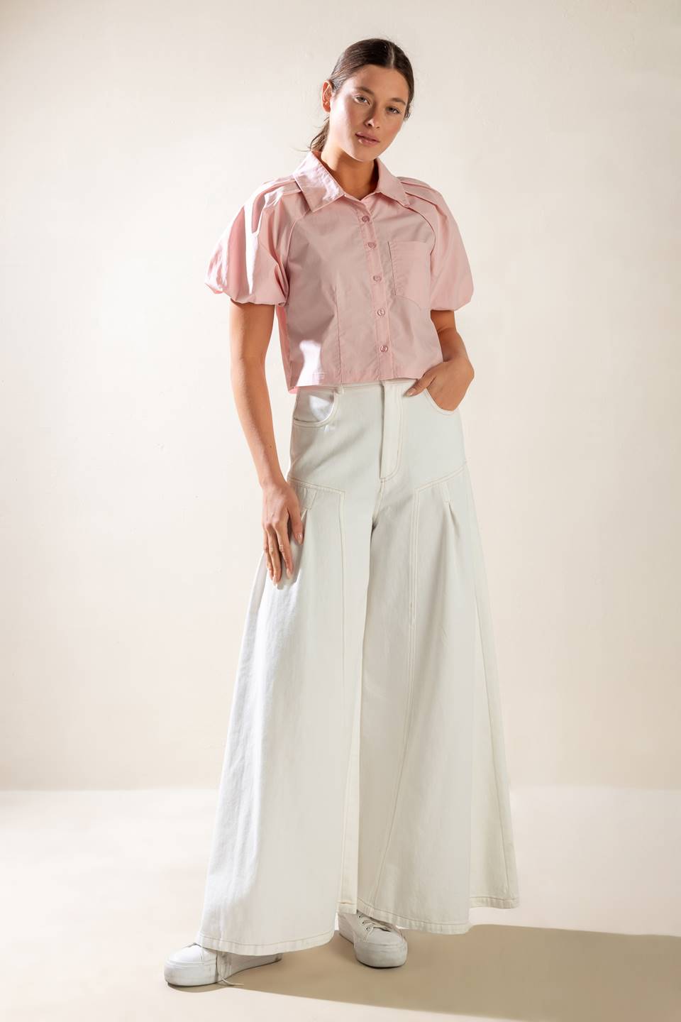 A solid baby pink woven top featuring collar, button down and short puff sleeve.