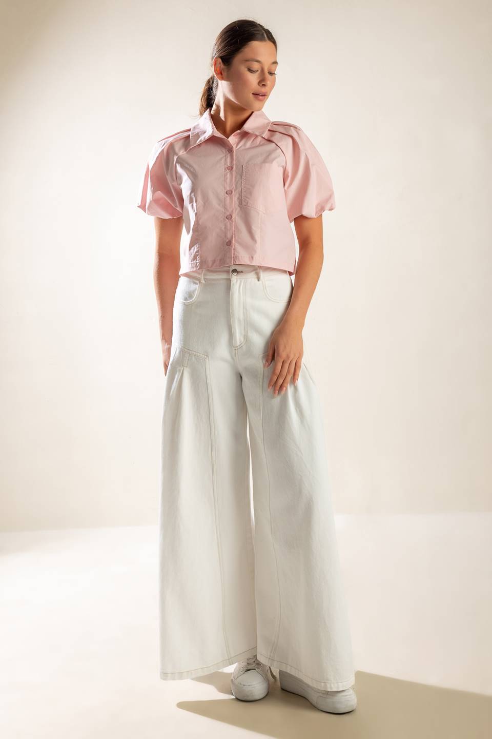 A solid baby pink woven top featuring collar, button down and short puff sleeve.