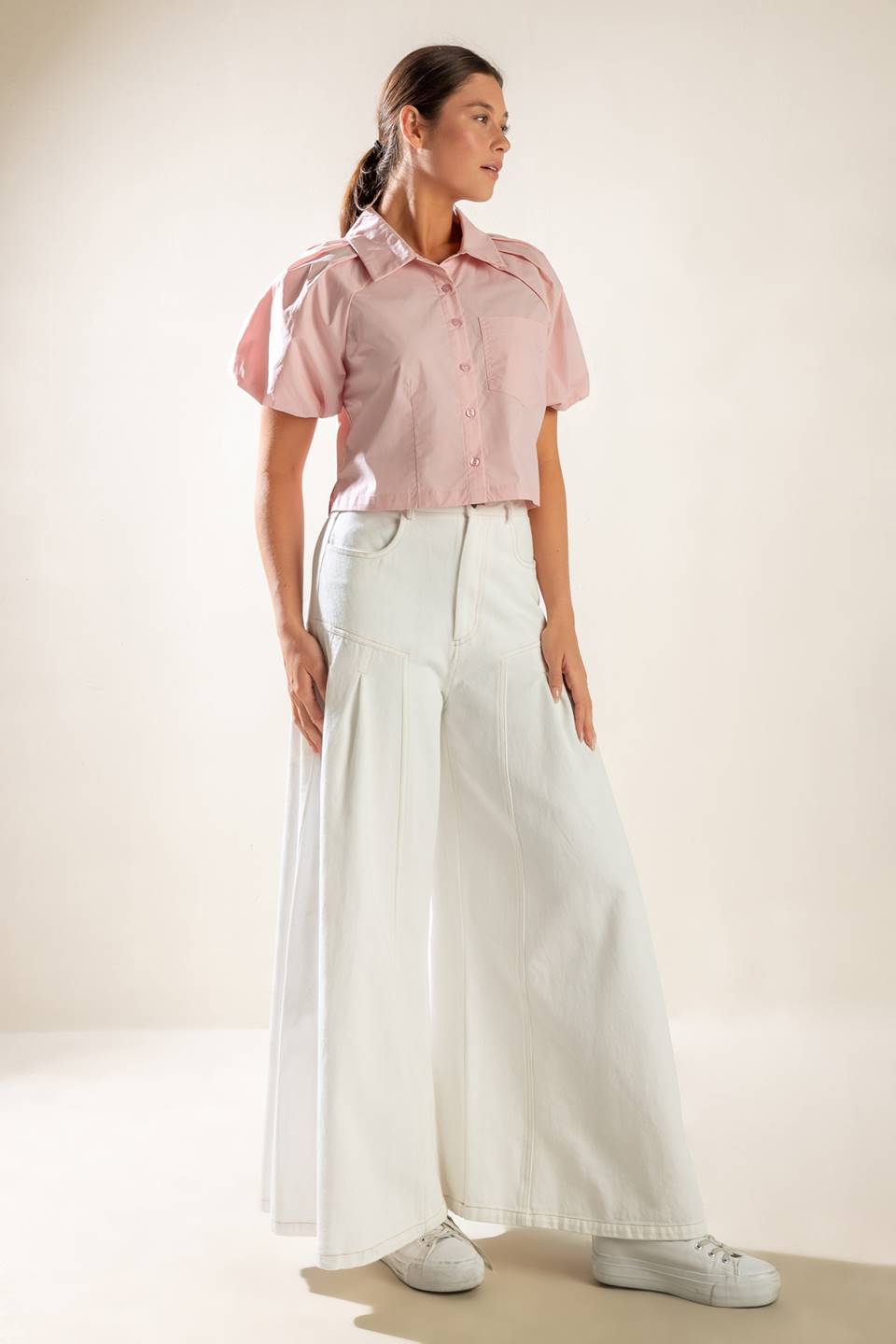 A solid baby pink woven top featuring collar, button down and short puff sleeve.