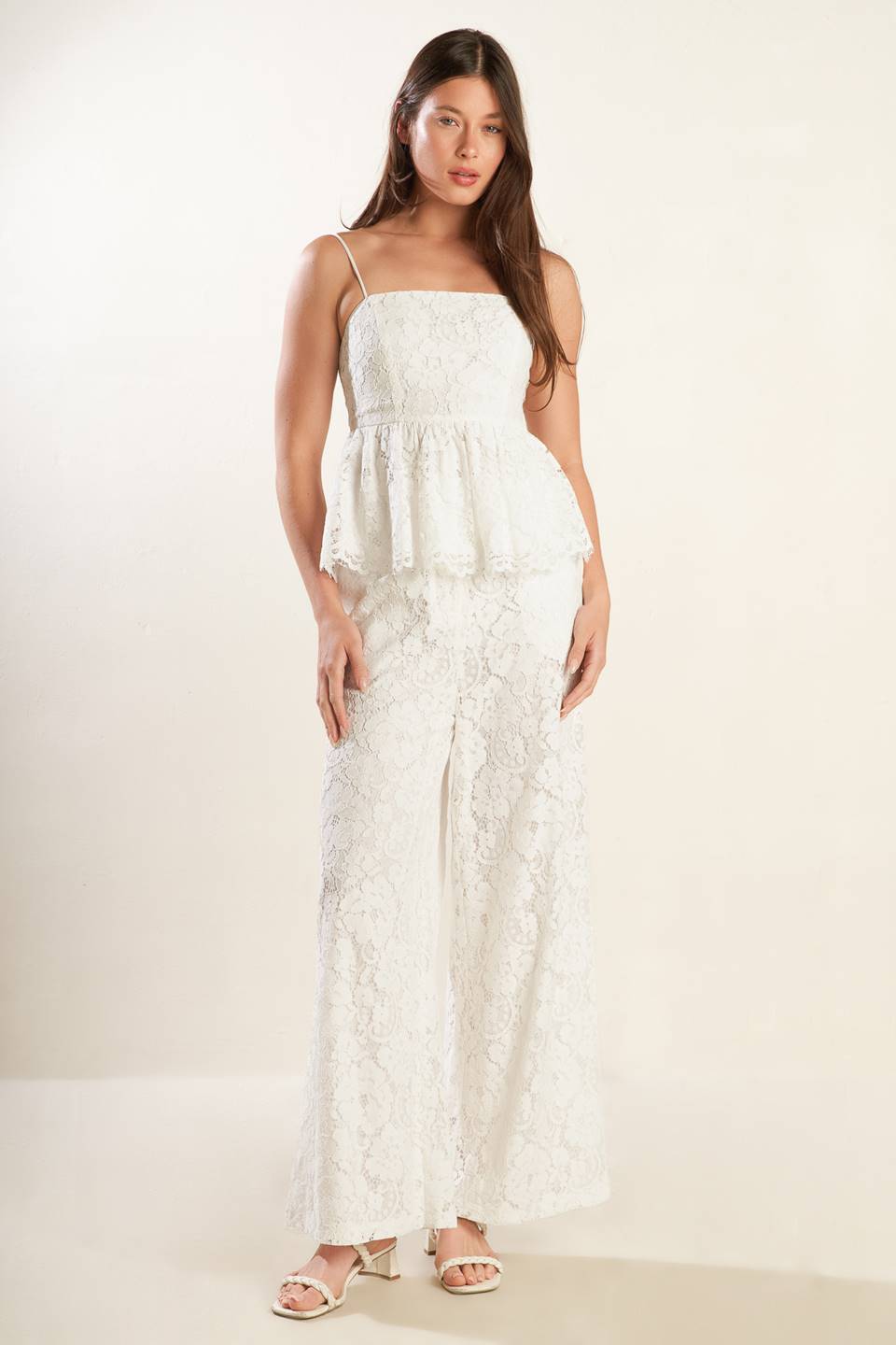 A white woven lace top featuring straight neckline, straps, peplum and back zipper closure.