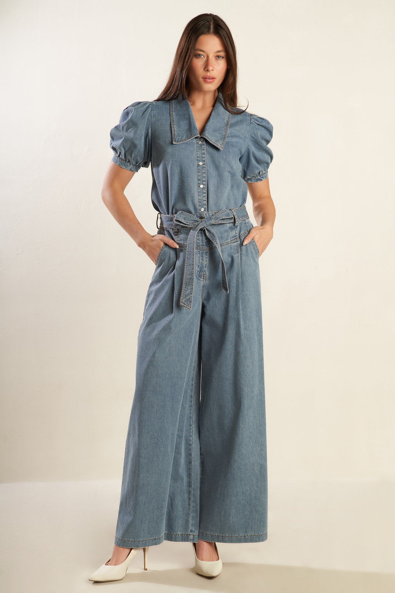 A light denim washed chambray top featuring collar, short puff sleeve with cuff and button down.