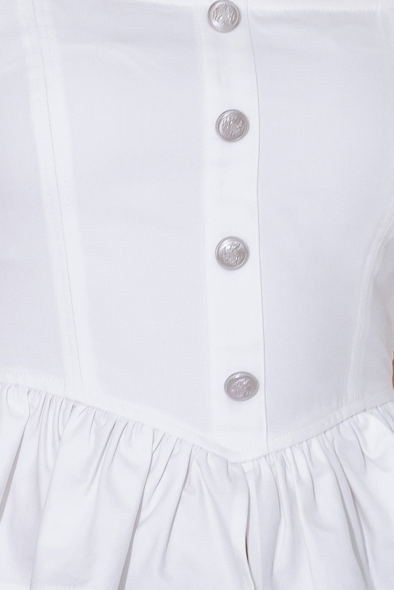 A solid woven top featuring square neckline, sleeveless, front button trim, ruffled peplum and smocked back bodice