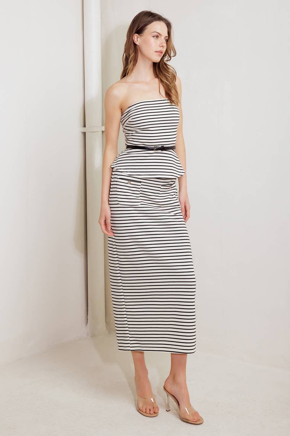 A striped woven tube top with contrasting belt, peplum and back zipper closure.