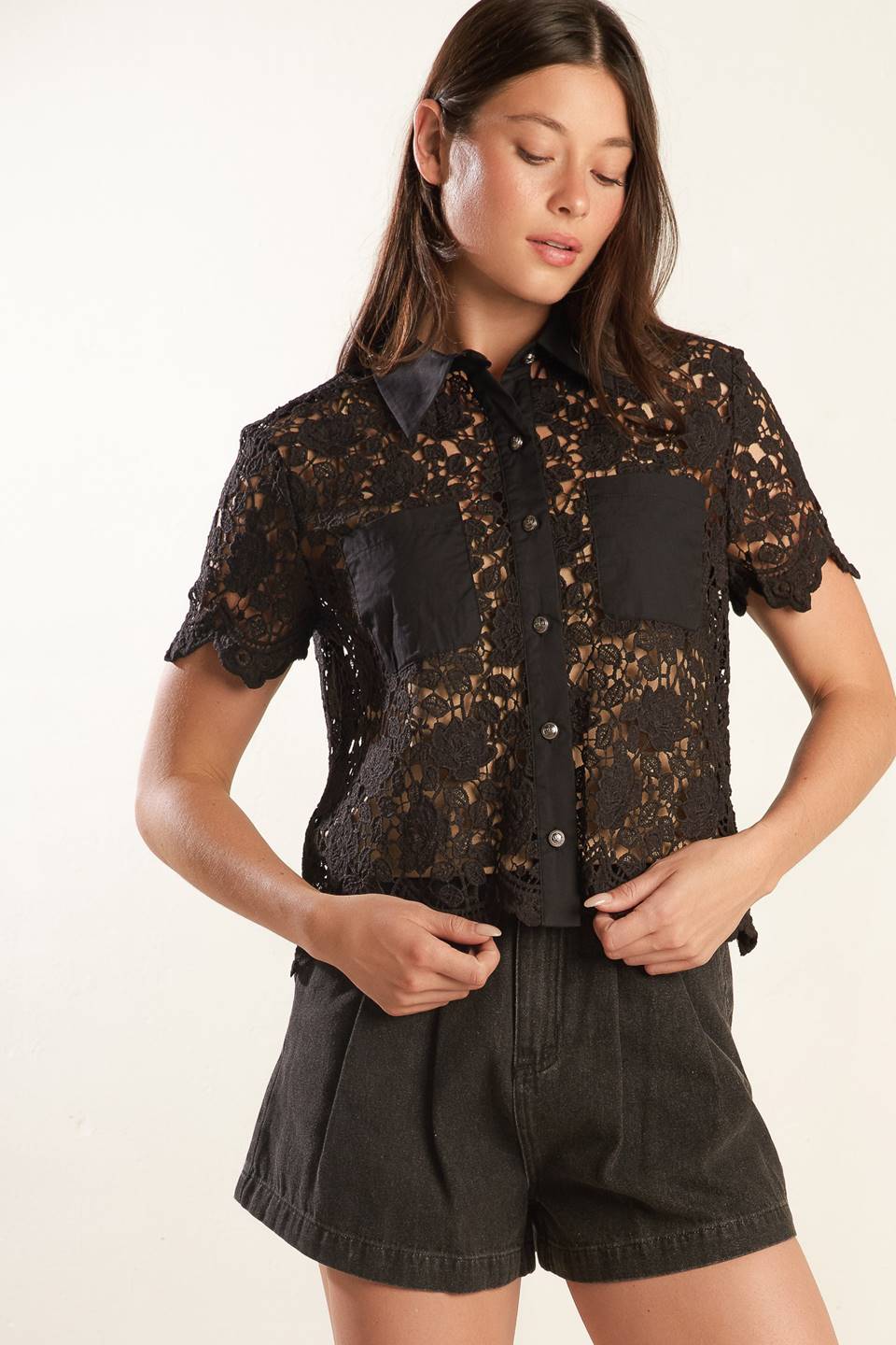 A black woven lace top with a collar, button down, and short sleeve 