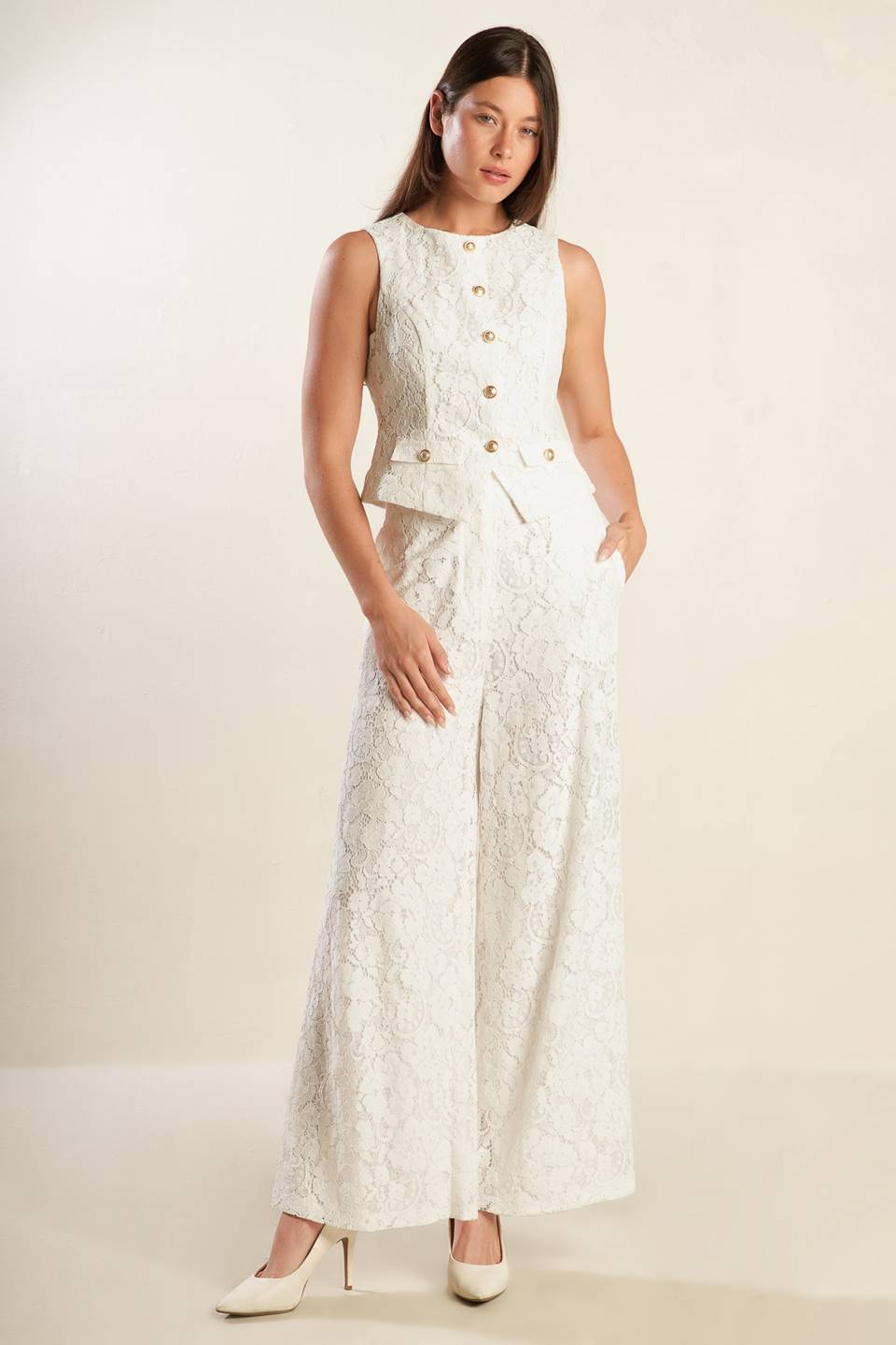 A white sleeveless woven lace vest featuring round neckline and button down.