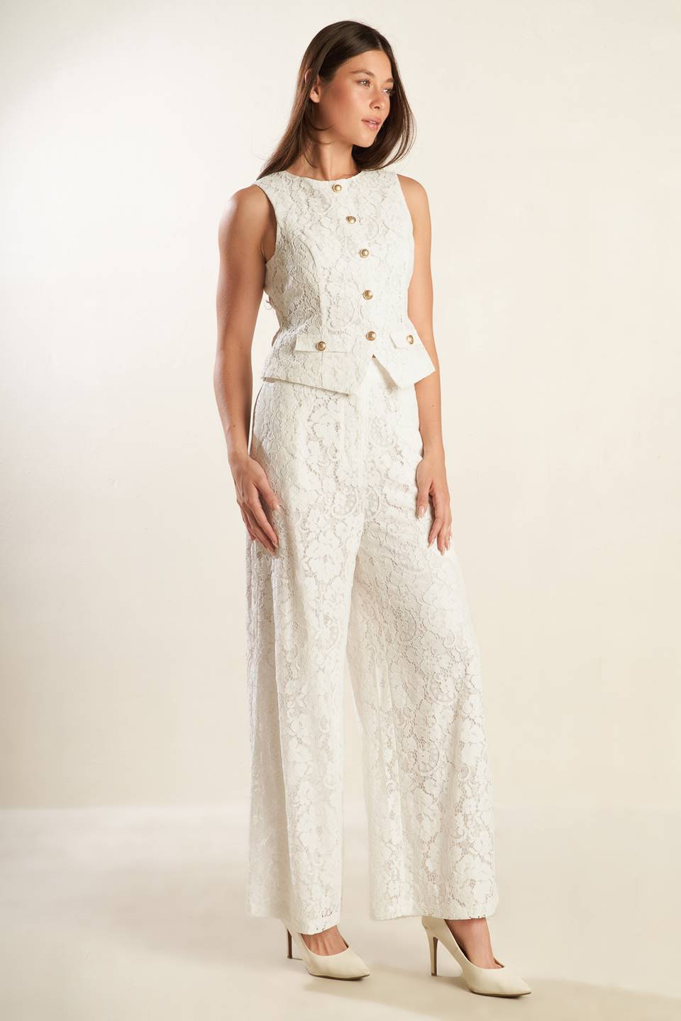 A white sleeveless woven lace vest featuring round neckline and button down.