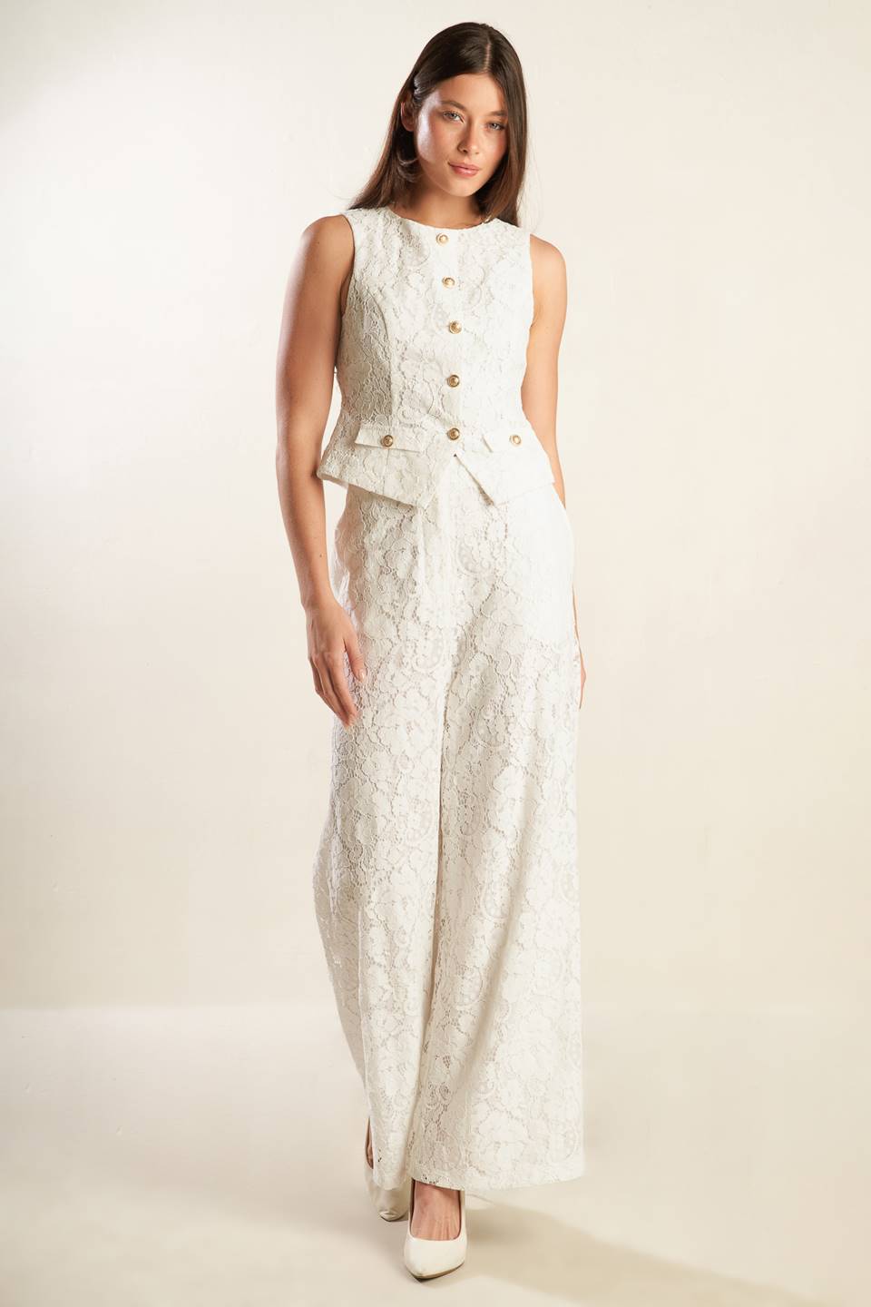 A white sleeveless woven lace vest featuring round neckline and button down.