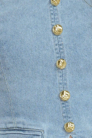 A washed denim top featuring strapless, front button-down detail and back zipper closure.