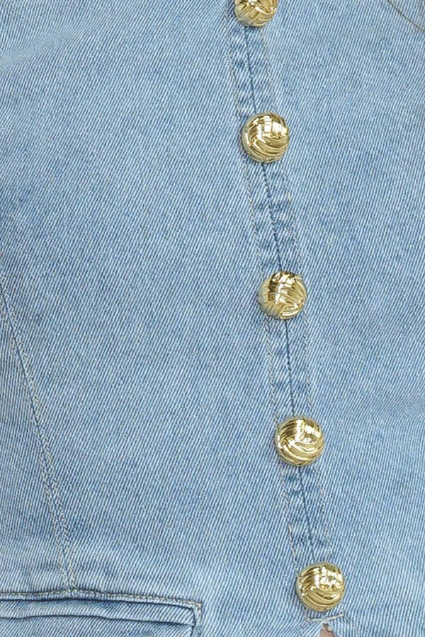 A washed denim top featuring strapless, front button-down detail and back zipper closure.