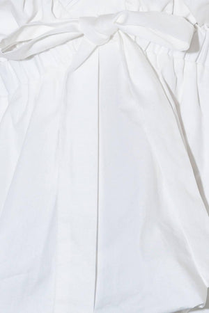 SLOW DOWN IN WHITE WOVEN TOP.