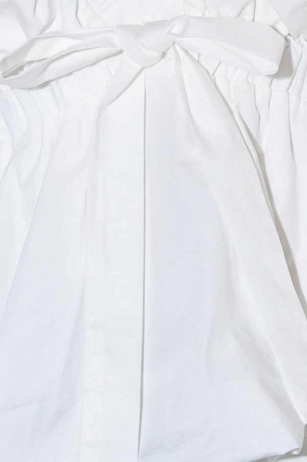 SLOW DOWN IN WHITE WOVEN TOP.