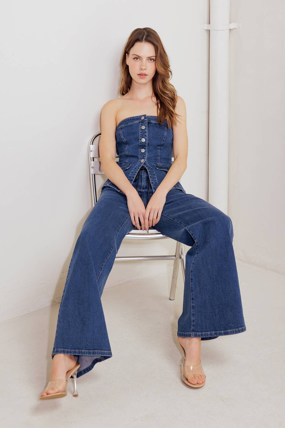 A strapless washed denim tube top with a button-down feature.