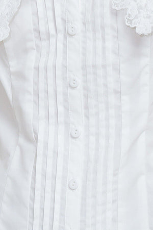 A solid woven top featuring V neckline, peter pan collar with lace trim, sleeveless, pin tuck front and button down closure