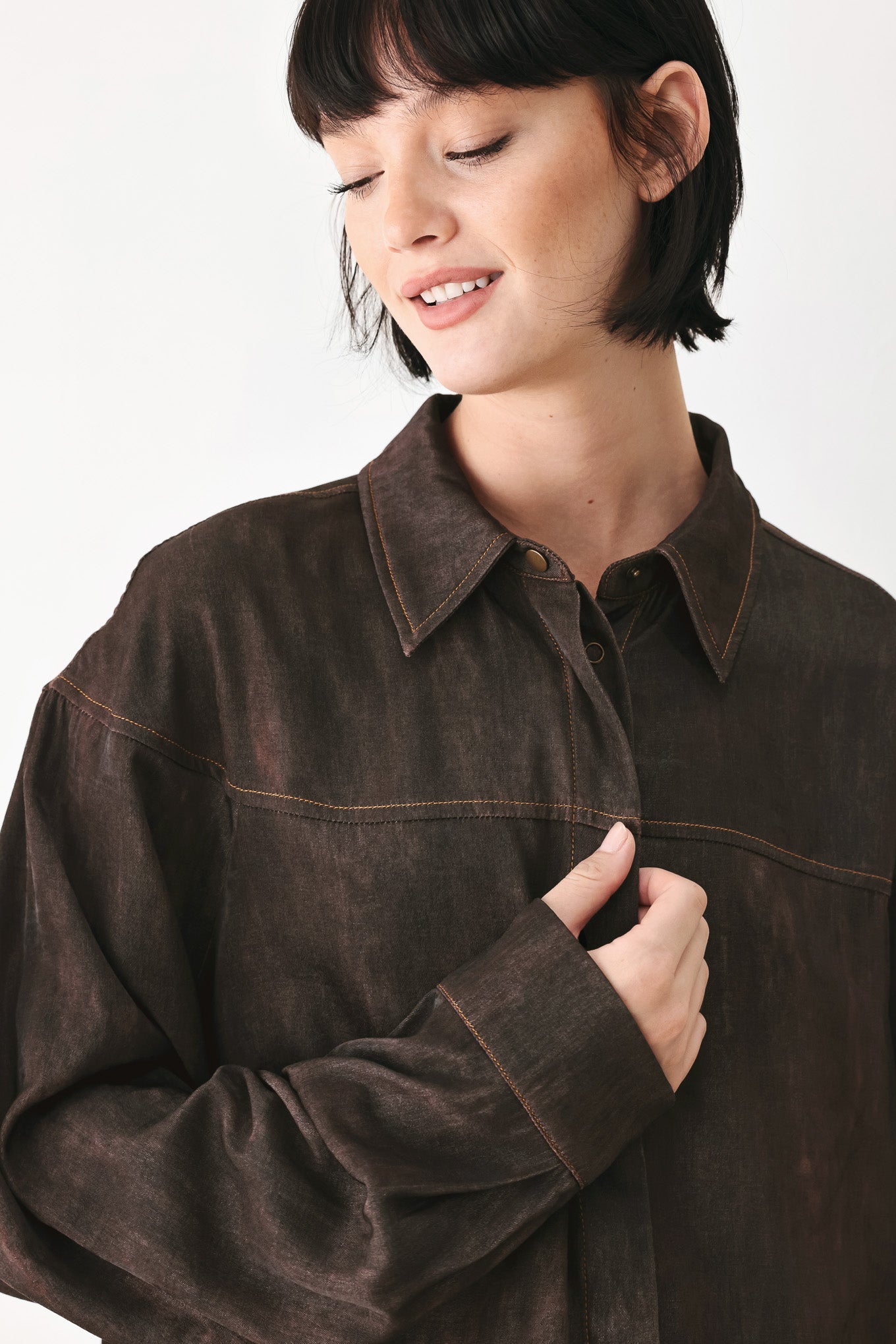 A model wearing a dark brown, washed-out button-up shirt | FREEMARKET