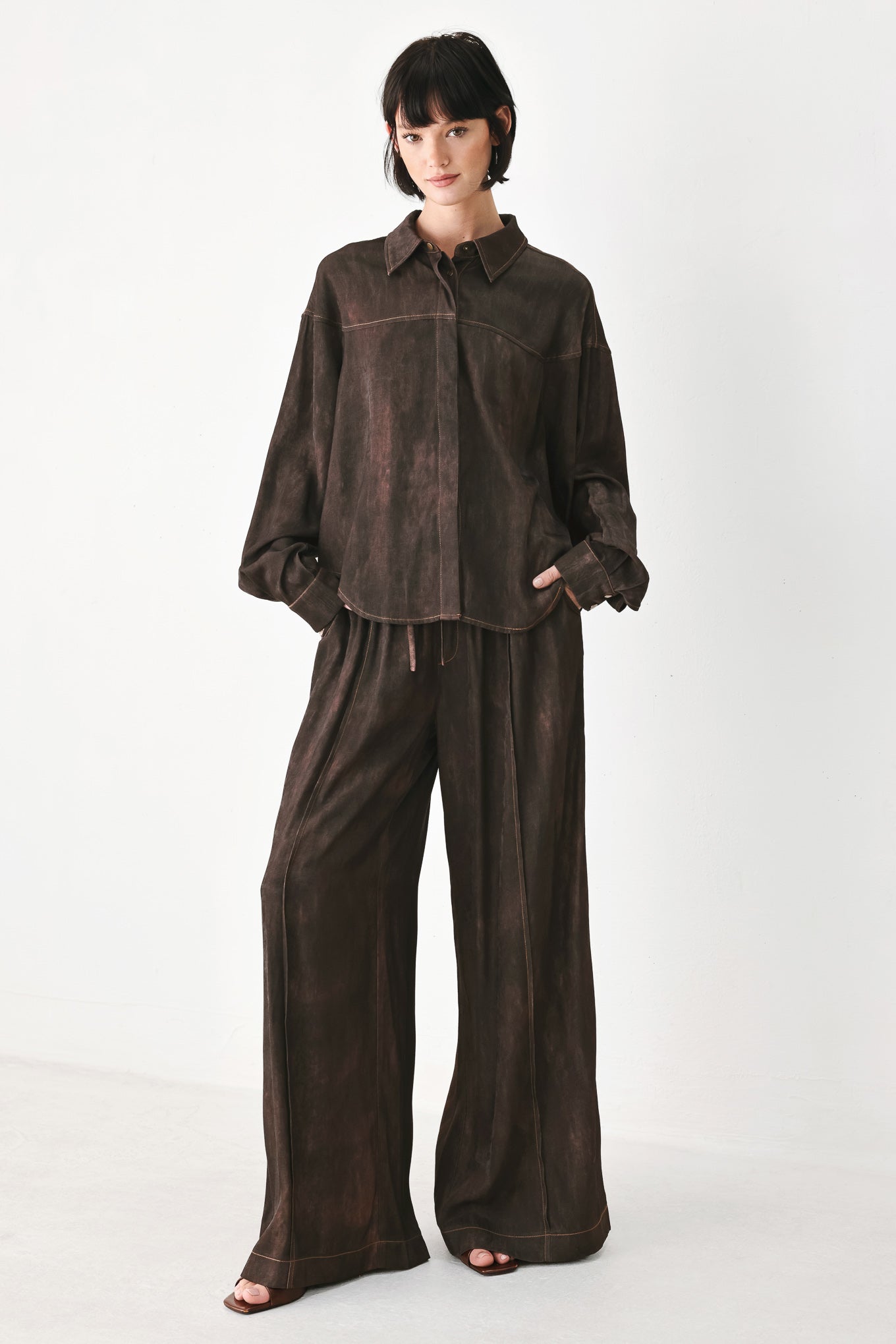 A model wearing a dark brown, washed-out button-up shirt | FREEMARKET