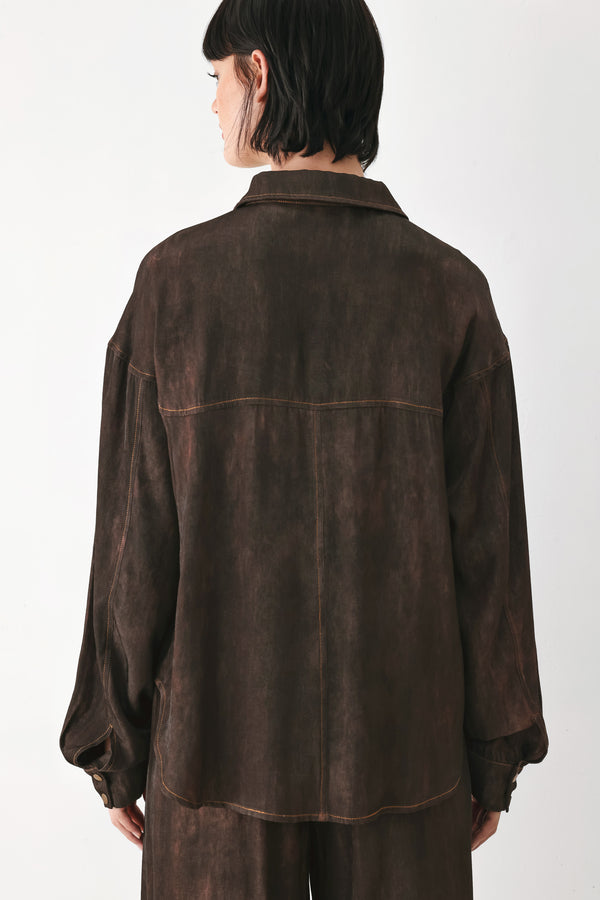 A model wearing a dark brown, washed-out button-up shirt | FREEMARKET