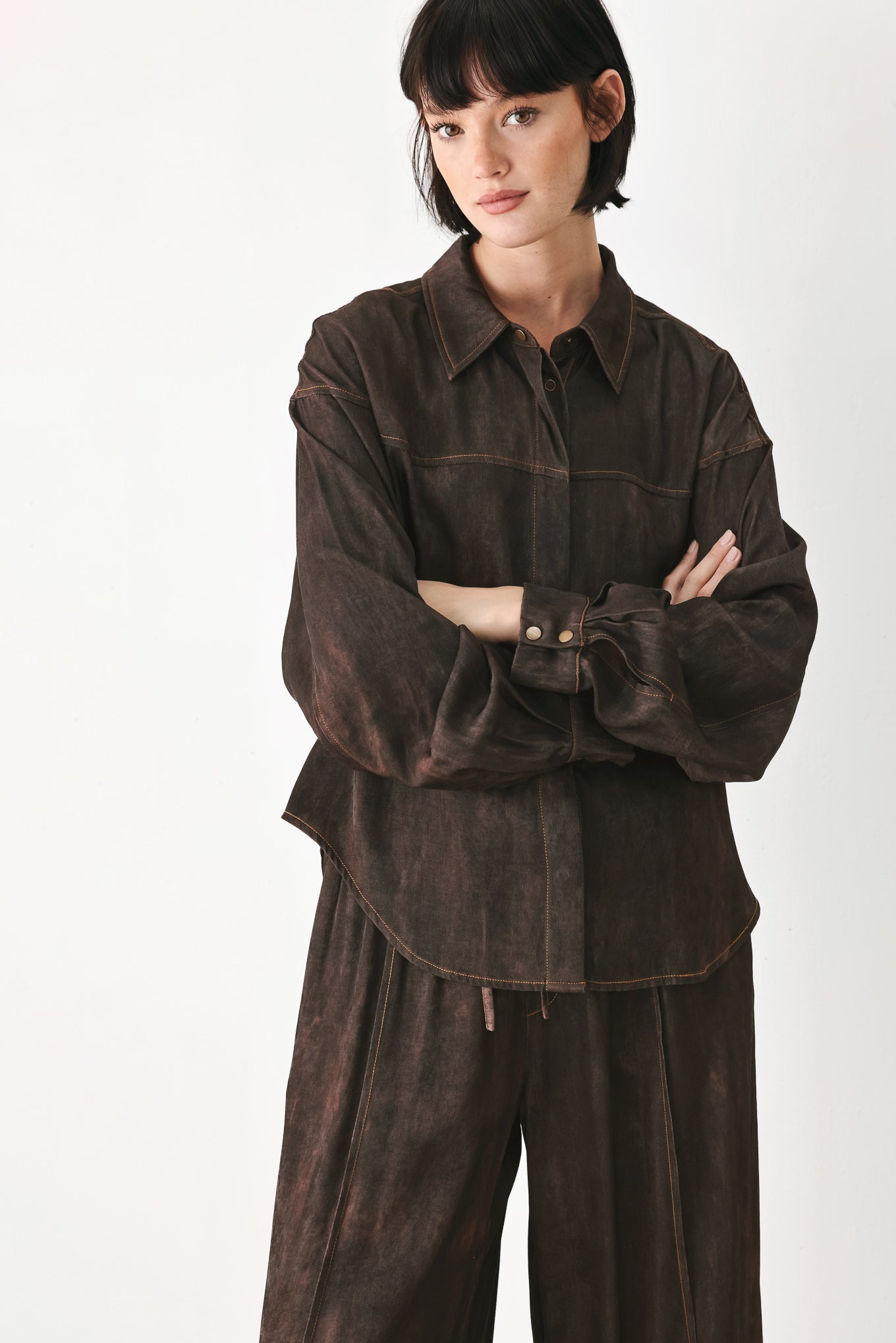 A model wearing a dark brown, washed-out button-up shirt | FREEMARKET