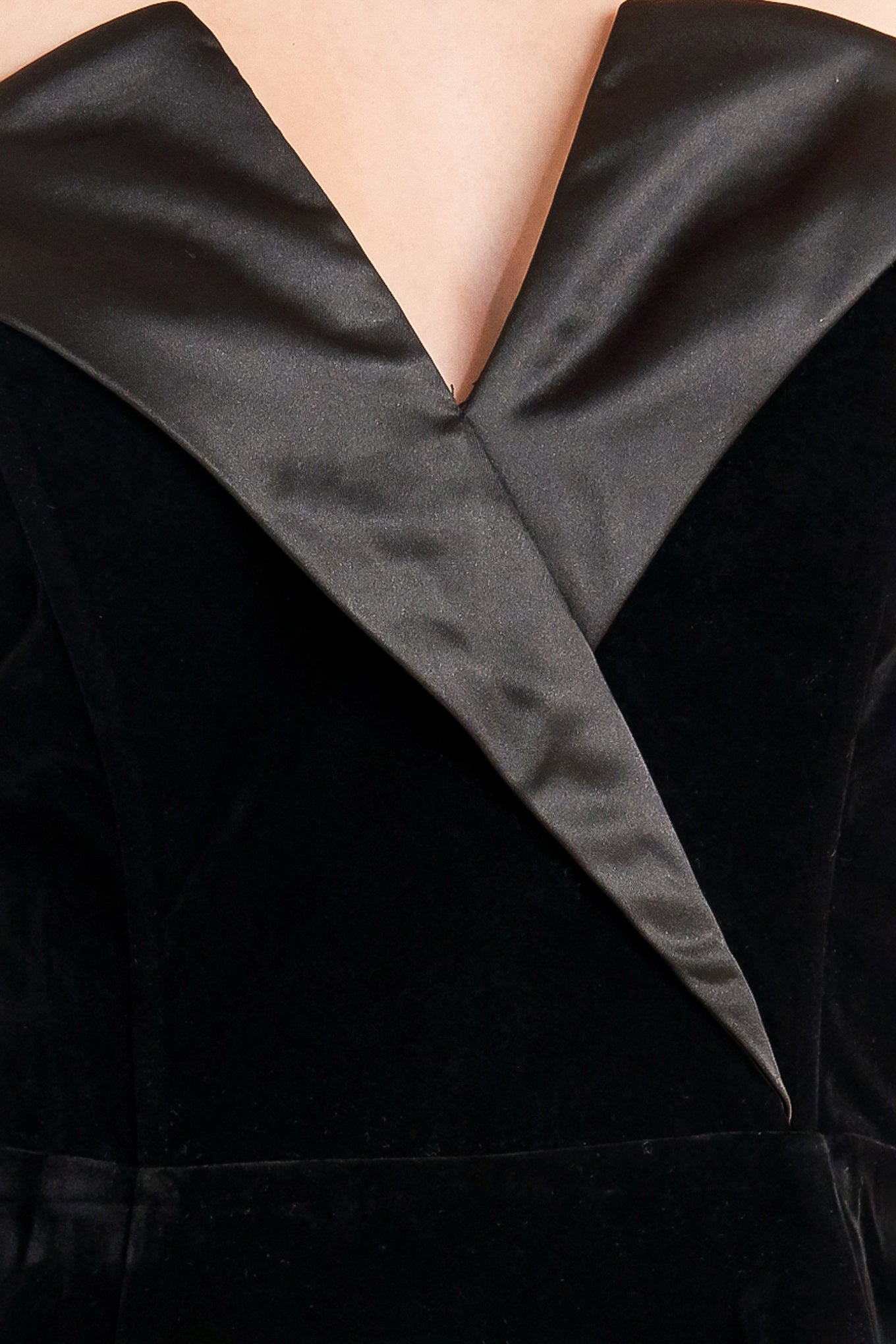 A velvet top featuring strapless, satin lapel, peplum and back zipper closure.