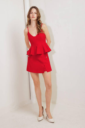 A solid woven cami top with peplum and back zipper closure.