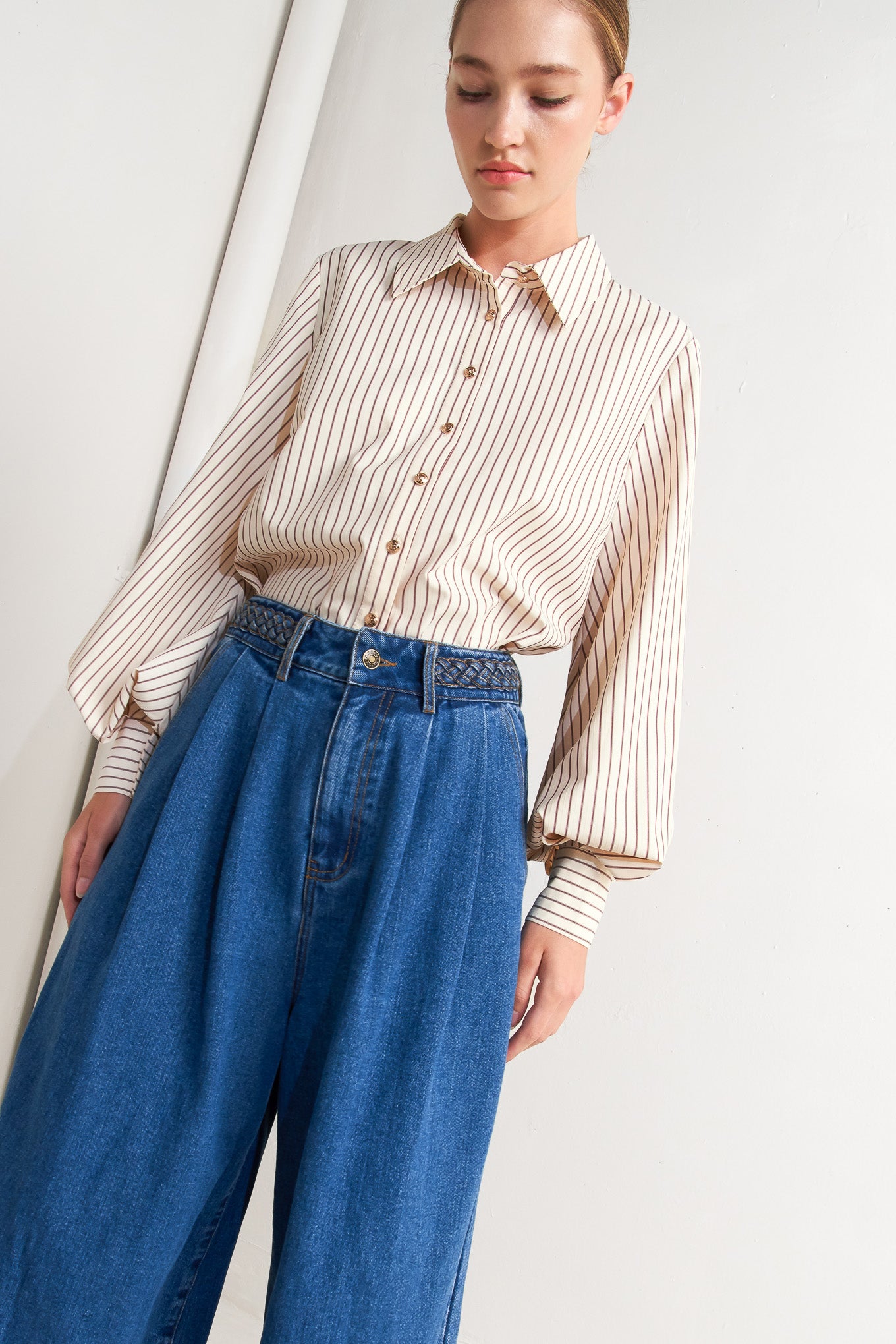 A striped woven top featuring collar, long sleeve and front button down