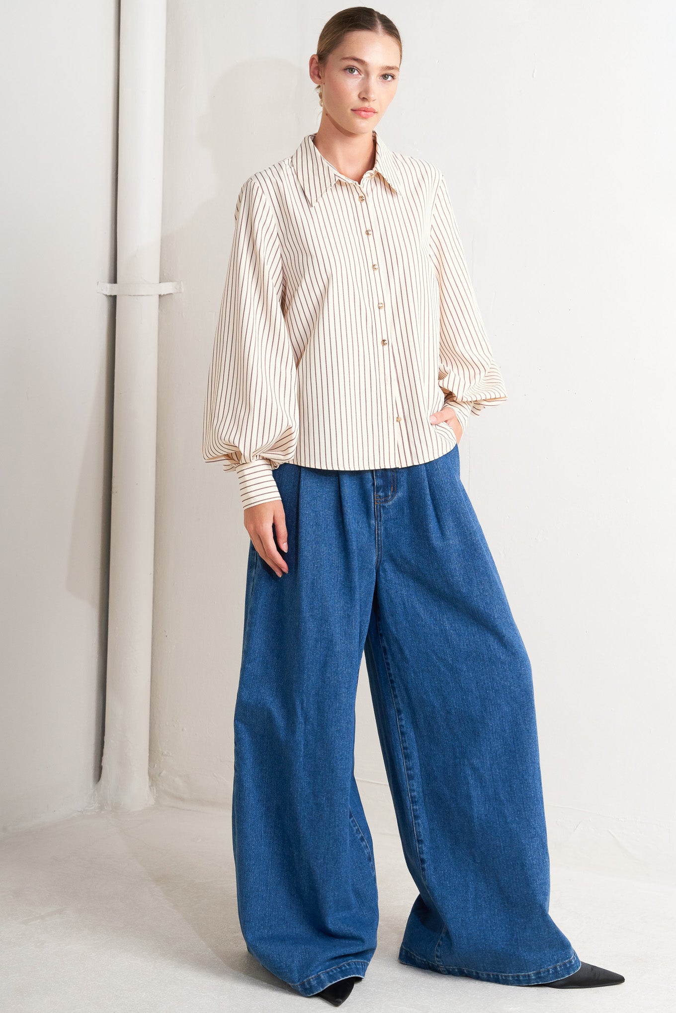 A striped woven top featuring collar, long sleeve and front button down