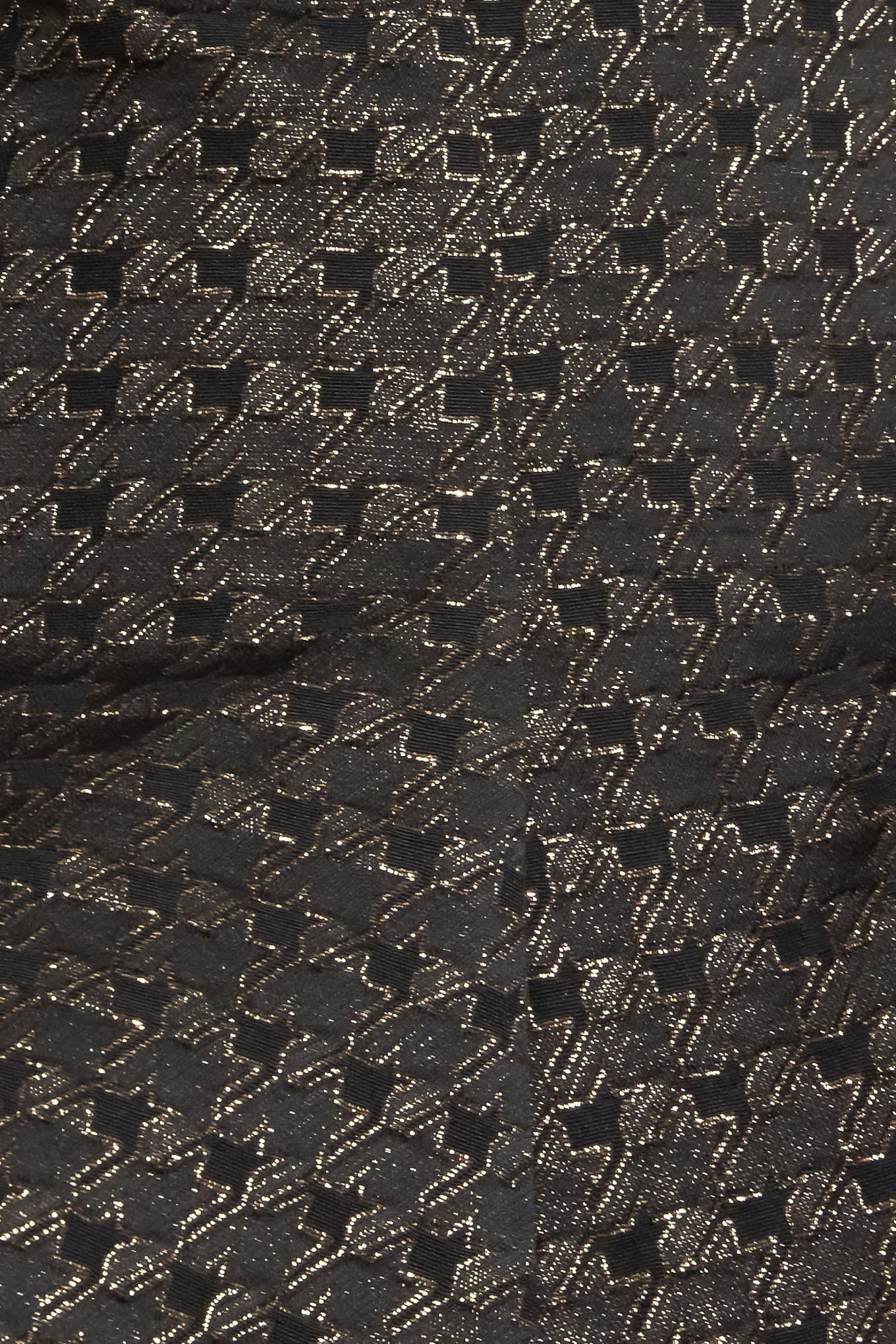 A textured metallic threaded woven top featuring strapless, peplum and back zipper closure.