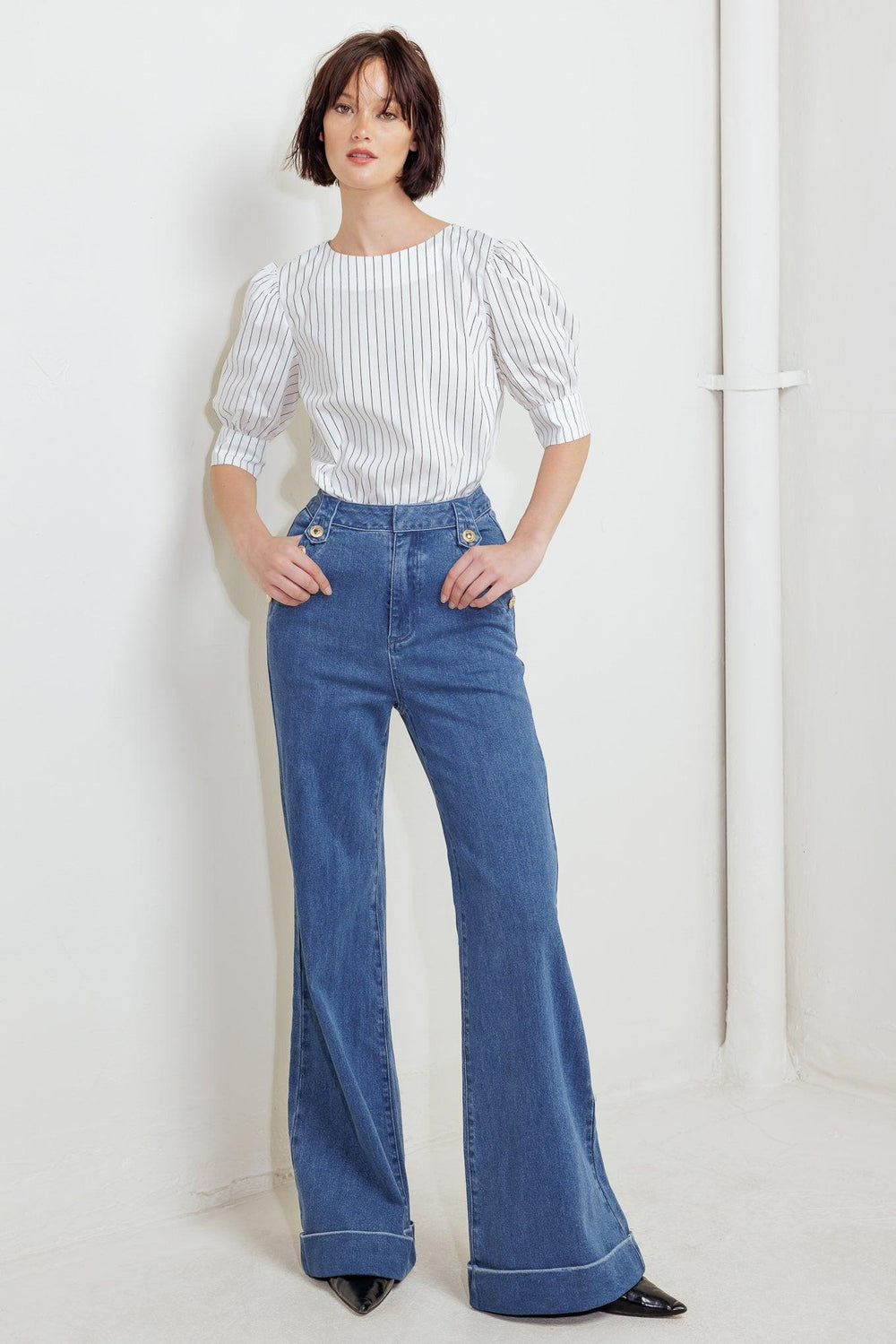 A striped woven top featuring round neckline, short puff sleeve with cuff and back button down closure
