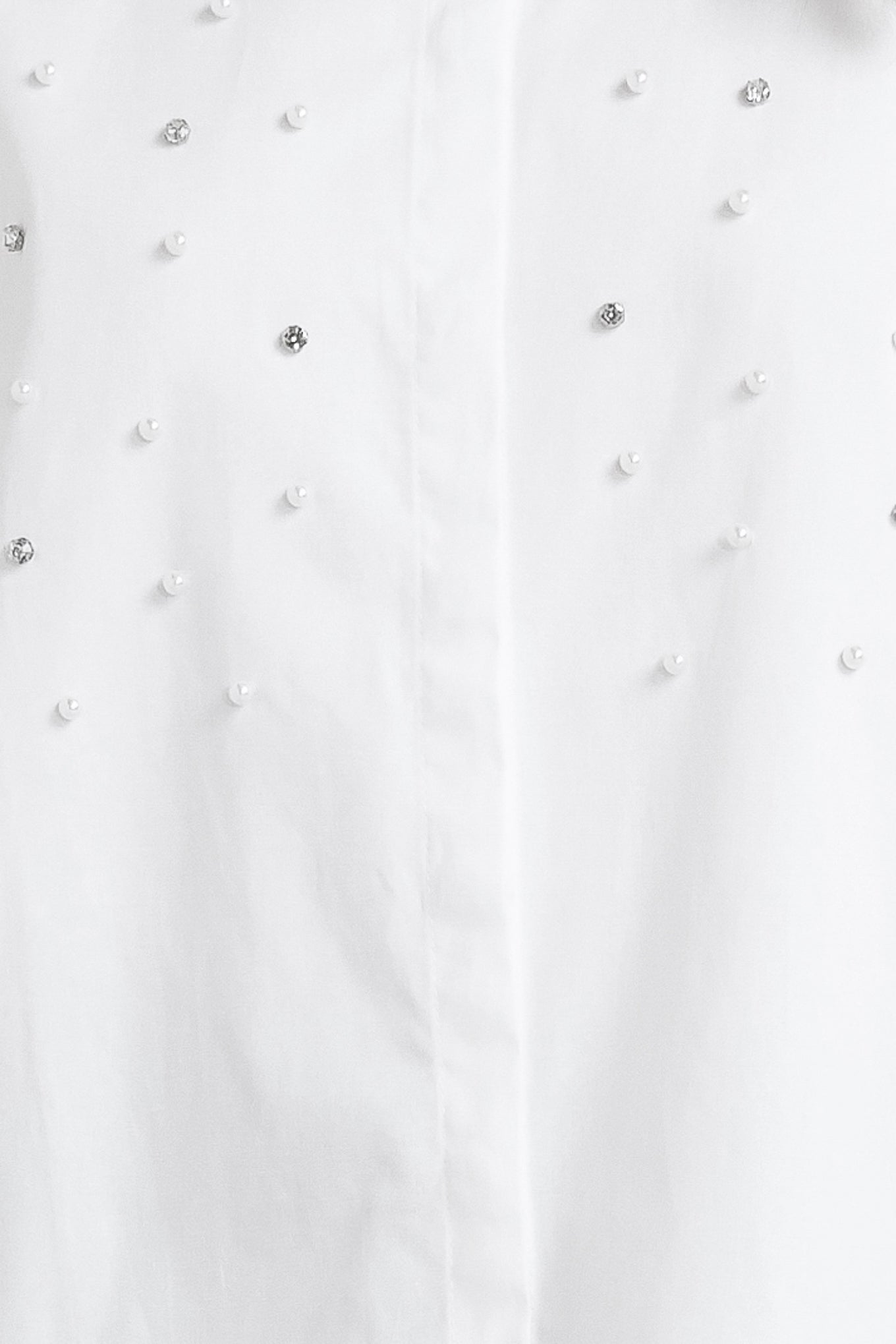 A woven shirt featuring collar, long sleeve, front button down and embellishment