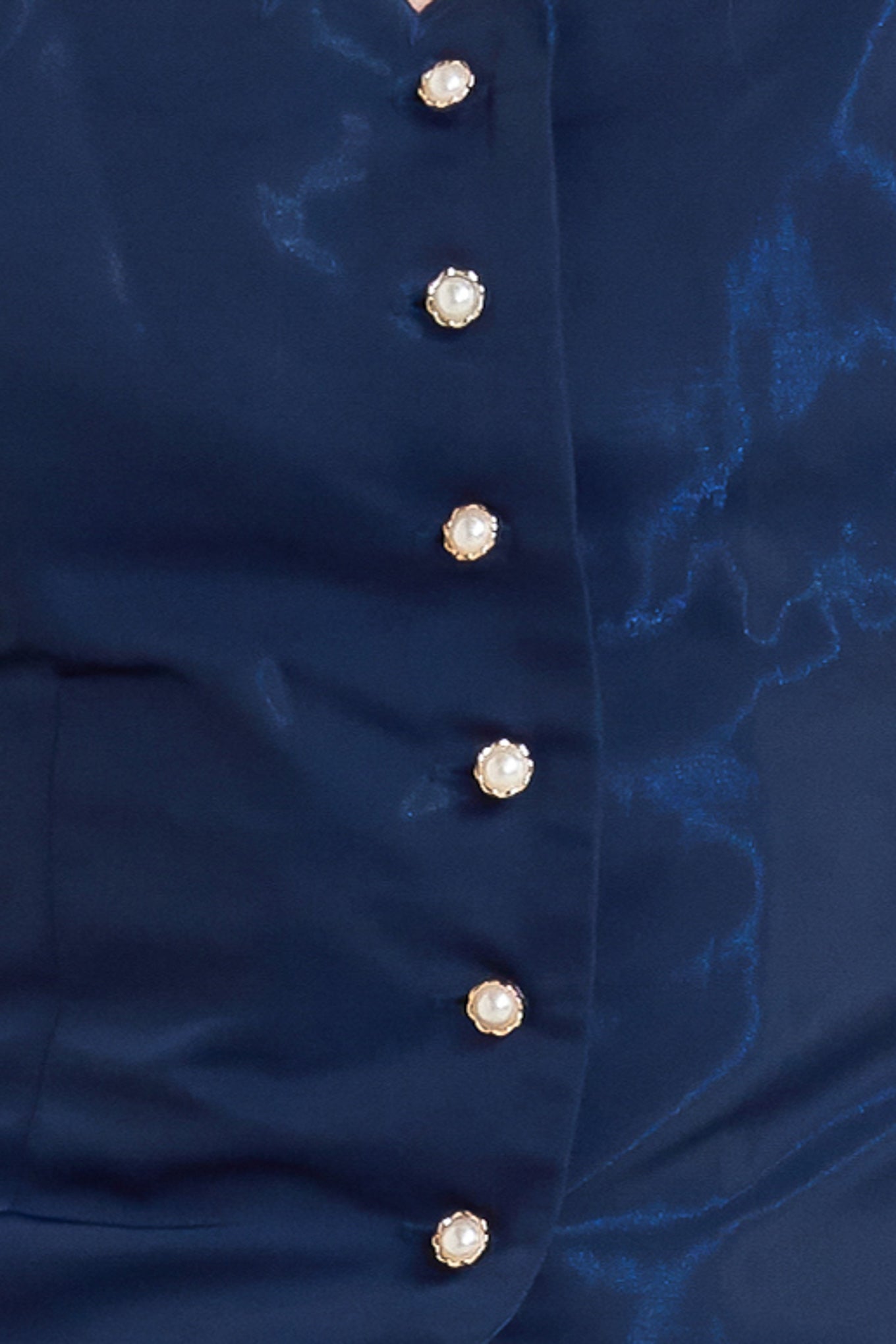 A solid woven top featuring scalloped edge square neckline, short puff sleeve and front button down