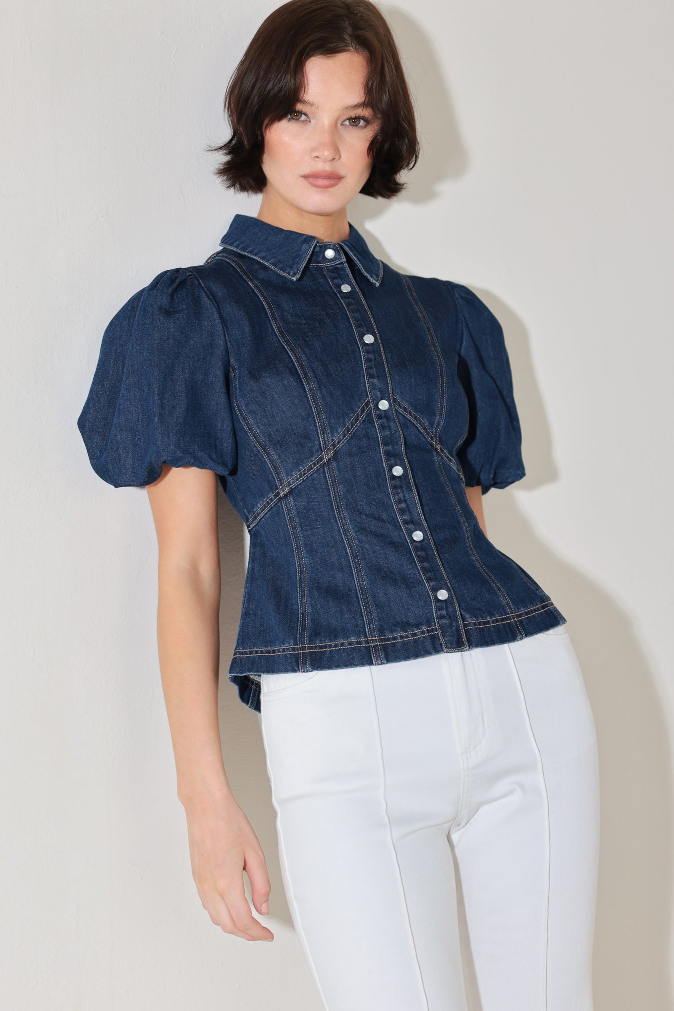 
A washed denim top featuring collar, short puff sleeve and front button down

Details:

Self : 81% Cotton 19% Polyester
Lining : 100% Polyester

Size &amp; Fit

- Model is 5`8" And Wearing Size Small
- Measurements Taken From Size Small
- Approx. Length: 22"