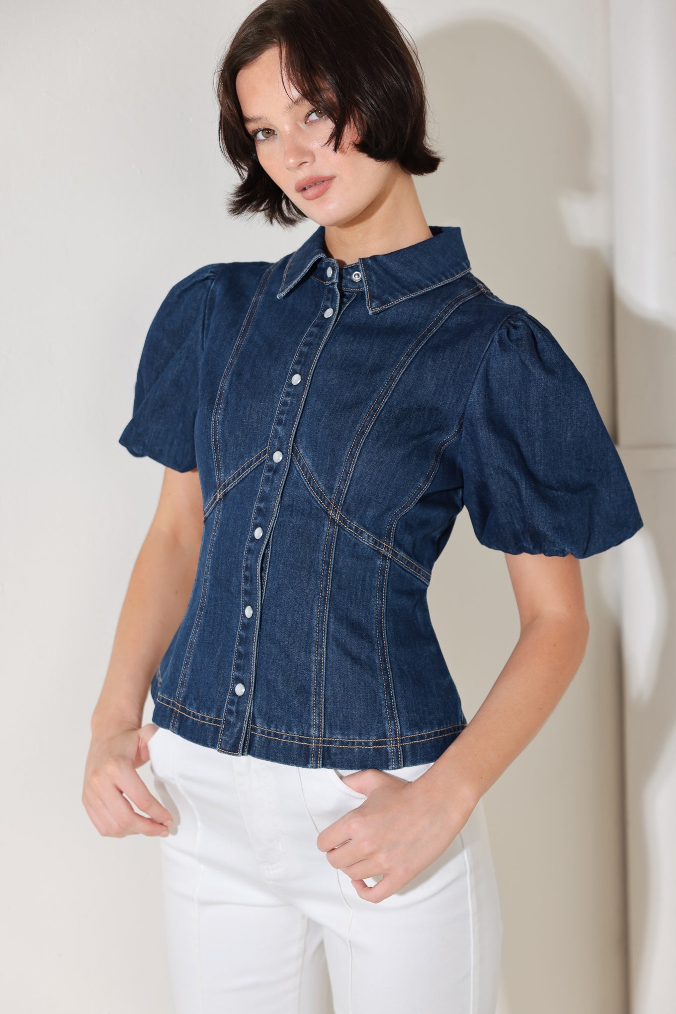 
A washed denim top featuring collar, short puff sleeve and front button down

Details:

Self : 81% Cotton 19% Polyester
Lining : 100% Polyester

Size &amp; Fit

- Model is 5`8" And Wearing Size Small
- Measurements Taken From Size Small
- Approx. Length: 22"