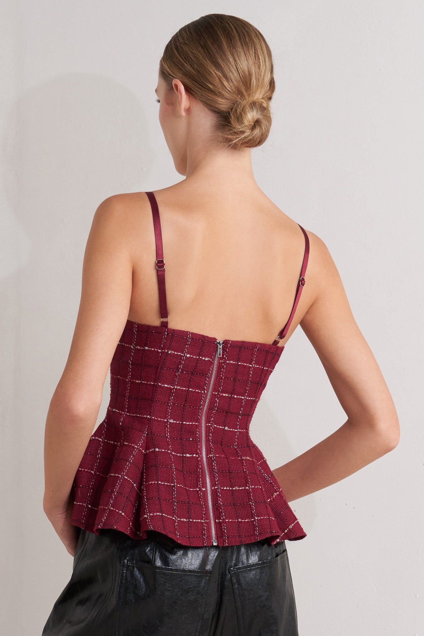 A tweed cami top featuring straps, peplum and back zipper closure